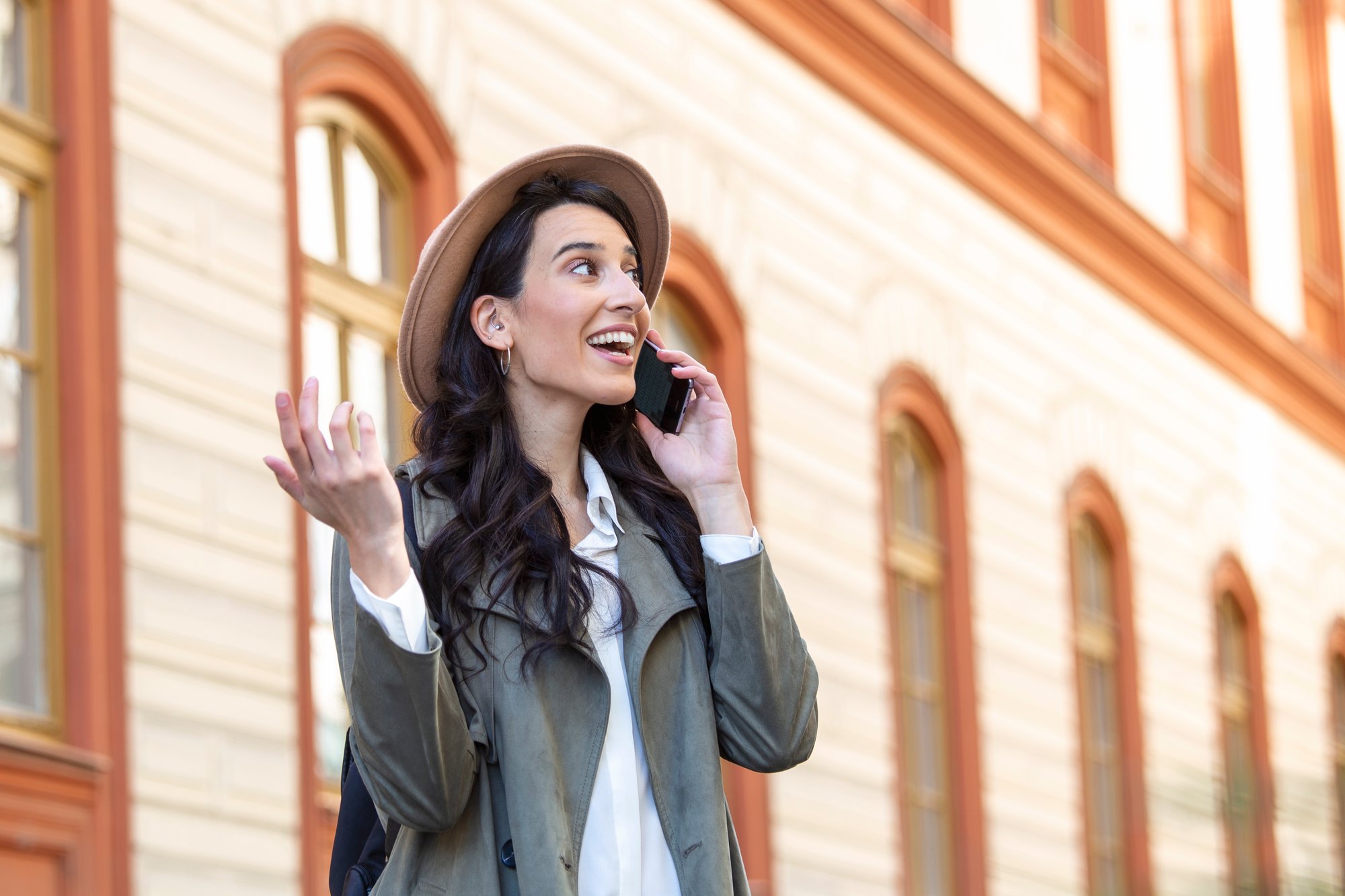 young-woman-talking-mobile-phone-looking-away-successful-girl-casual-calling-smartphone-city-while-standing-sidewalk-beautiful-woman-talking-phone-while-walking-street